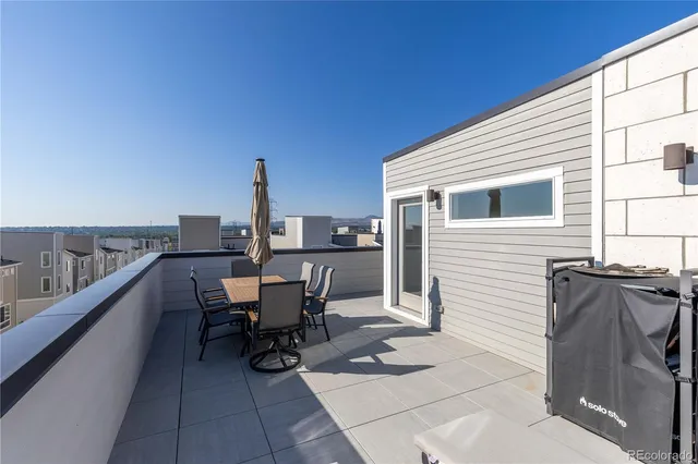 a view of a terrace with furniture and stove