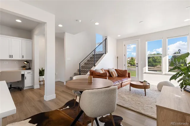 a living room with furniture and large windows
