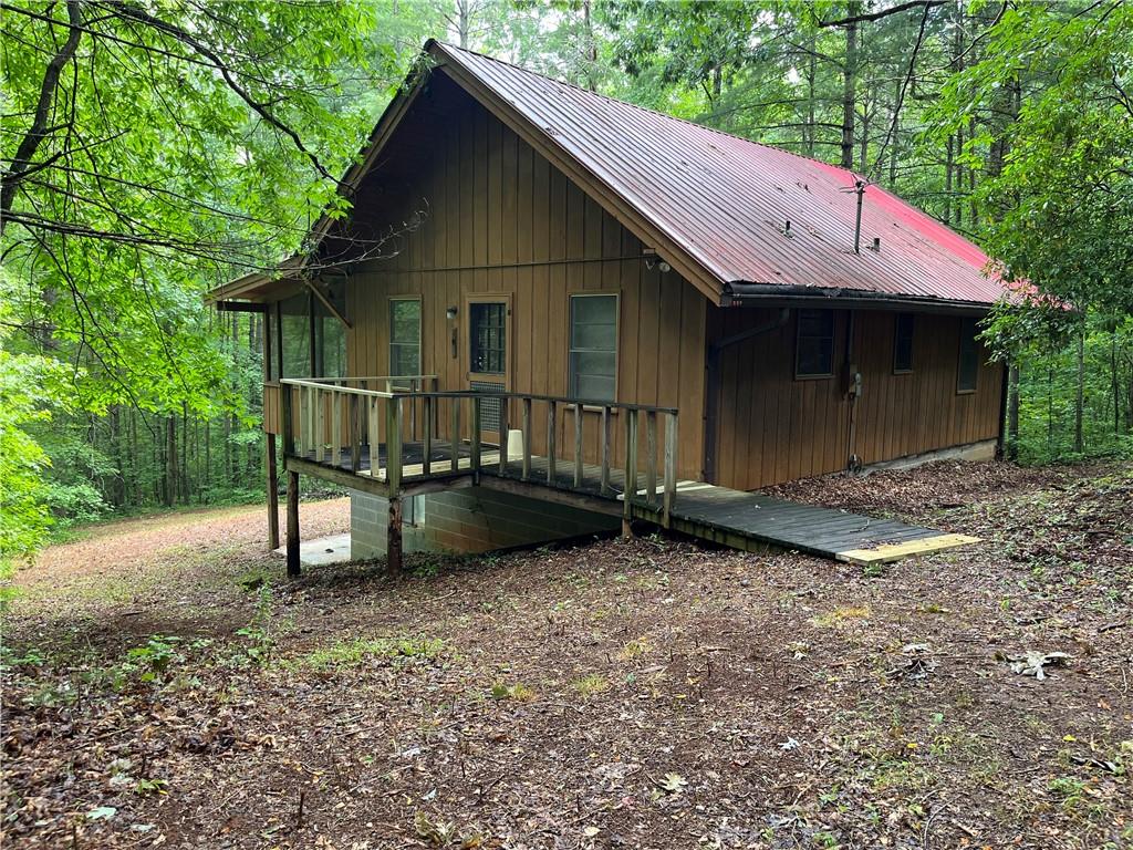 125 Derby Lane Cleveland, GA 30528 - Photo 1 of 1 a backyard of a house with table and chairs