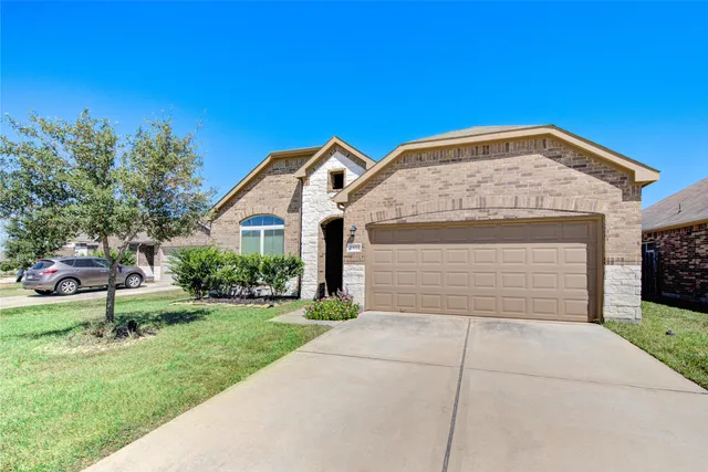 a front view of a house with a yard and garage