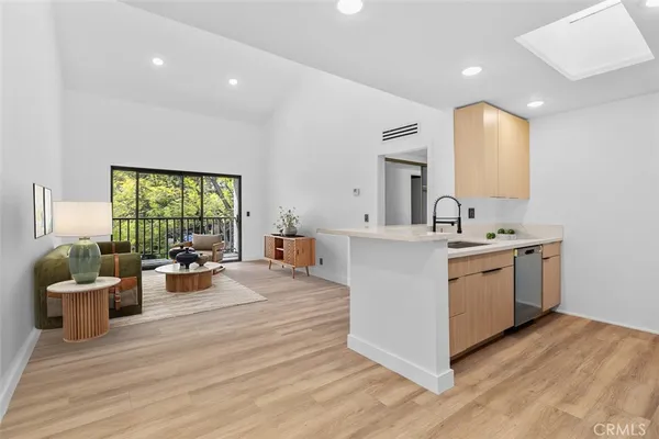 a large white kitchen with a large window
