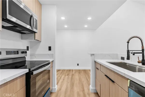 a kitchen that has a sink and a stove