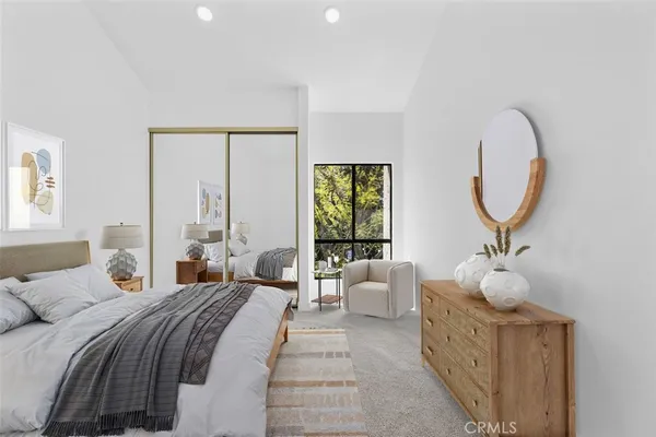 a bedroom with bed and a large window
