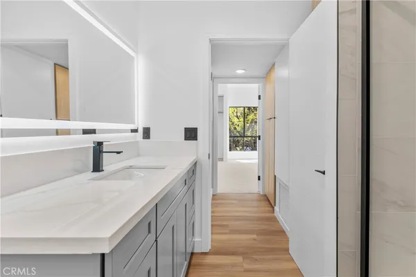 a view of a bathroom with a sink and a refrigerator