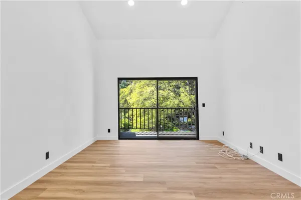 a hallway with a large dining table and a chandelier