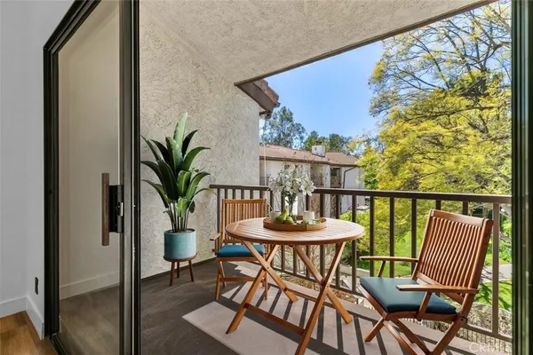 a view of a balcony with a table and chairs