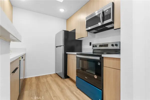 a kitchen with a refrigerator stove and microwave