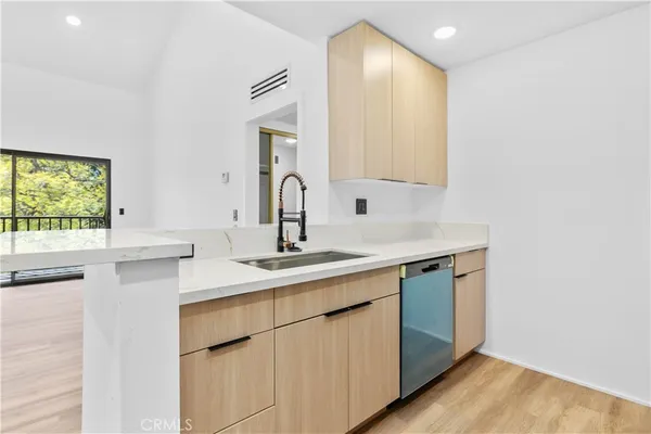 a kitchen with a sink cabinets and window
