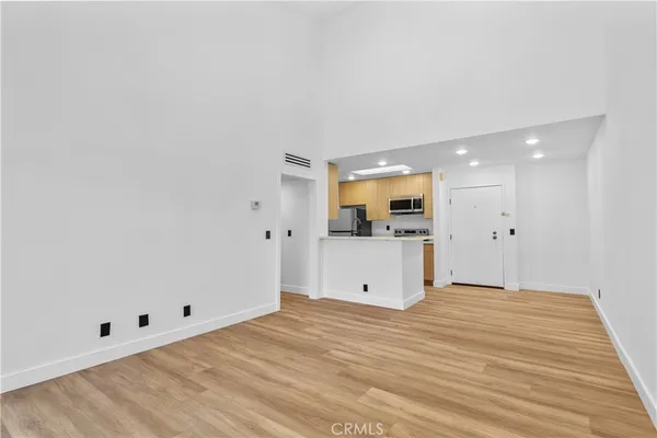 a view of a kitchen with wooden floor and a sink
