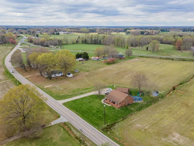 an aerial view of a house with outdoor space