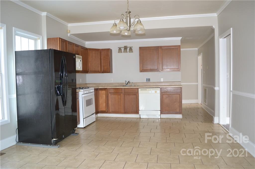 489 Union Cemetery Road Southwest Concord, NC 28027 - Photo 5 of 19 a kitchen with stainless steel appliances granite countertop a refrigerator and a sink