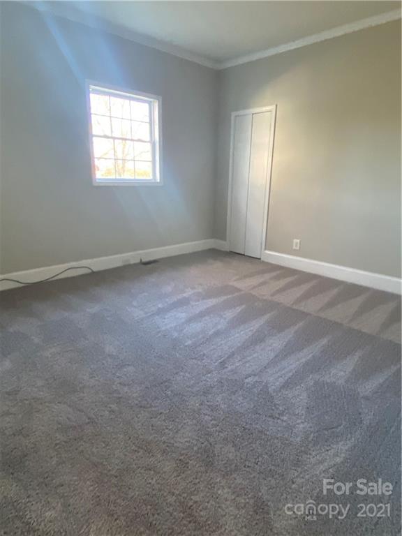 489 Union Cemetery Road Southwest Concord, NC 28027 - Photo 7 of 19 an empty room with windows and closet