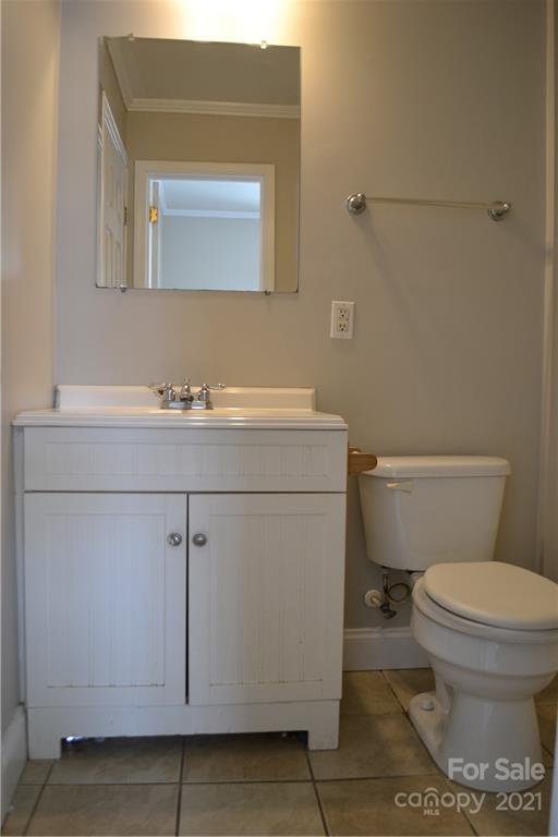489 Union Cemetery Road Southwest Concord, NC 28027 - Photo 9 of 19 a bathroom with a toilet a sink and mirror