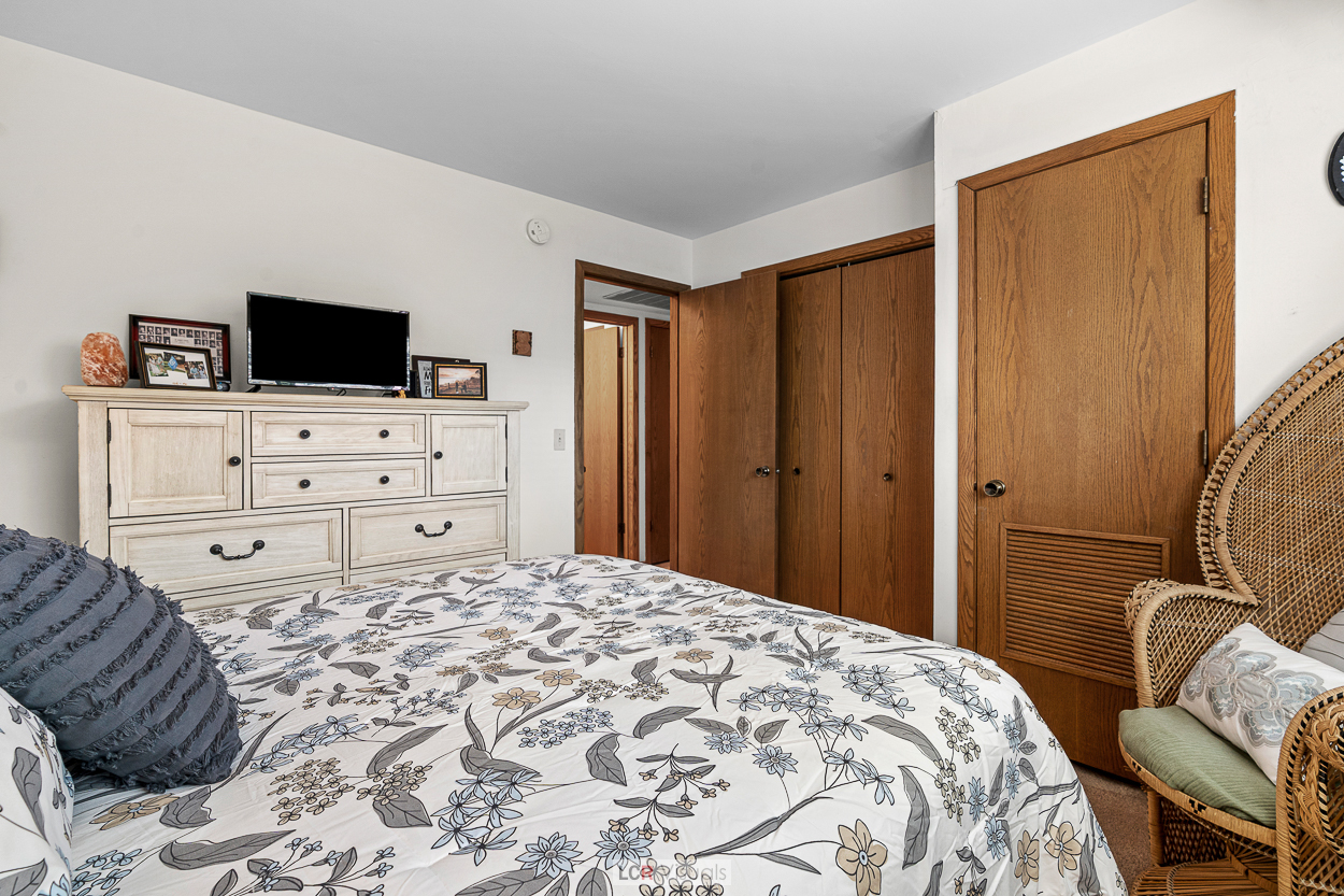 7616 West Lawrence Avenue, Unit 2B Harwood Heights, IL 60706 - Photo 11 of 15 a bedroom with a bed and furniture