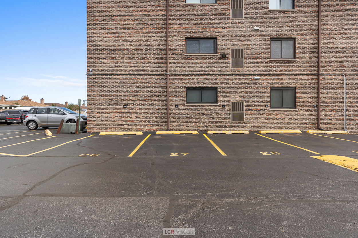 7616 West Lawrence Avenue, Unit 2B Harwood Heights, IL 60706 - Photo 15 of 15 a view of building with car parked