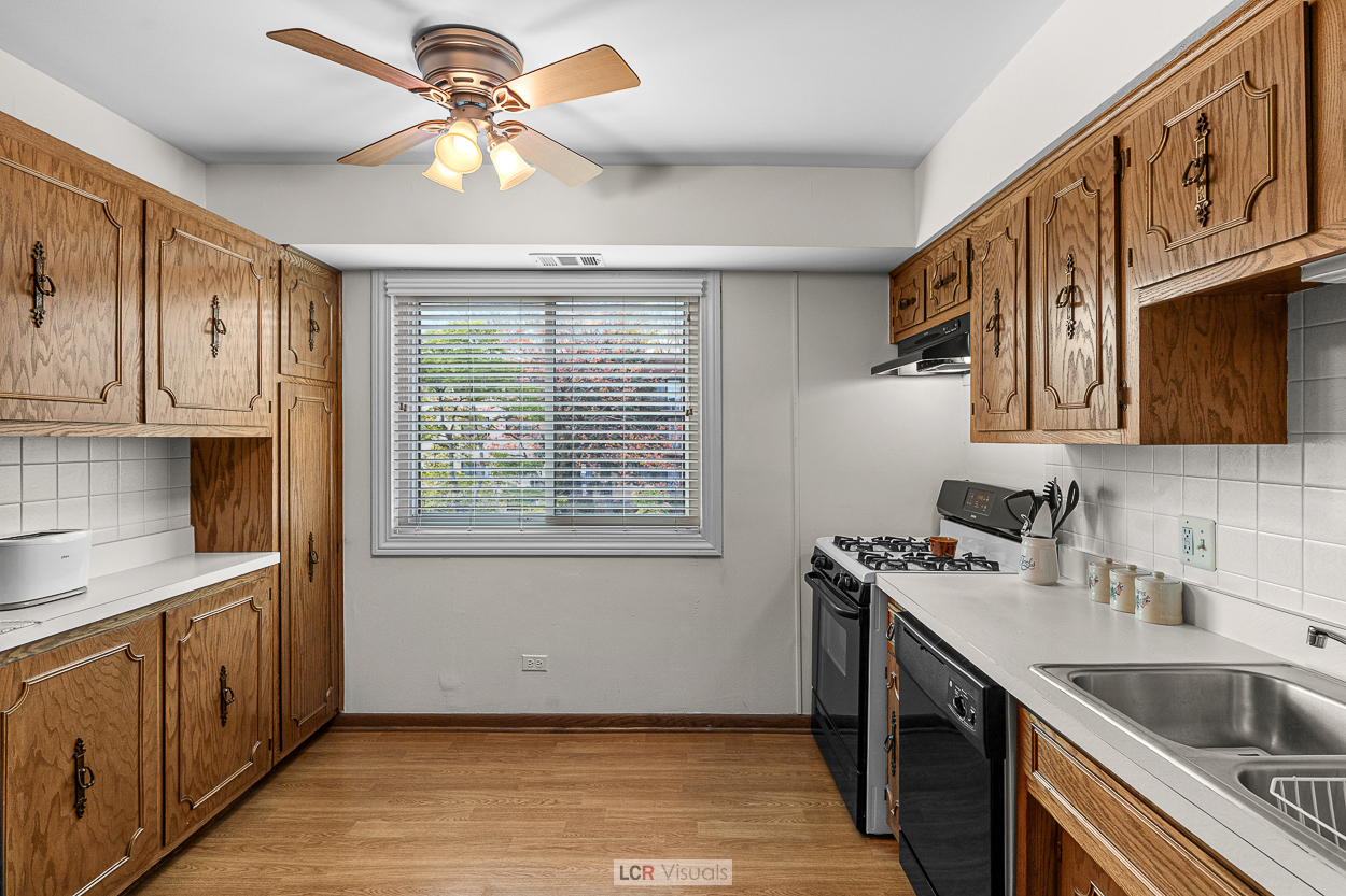 7616 West Lawrence Avenue, Unit 2B Harwood Heights, IL 60706 - Photo 6 of 15 a kitchen with stainless steel appliances granite countertop a sink stove and cabinets