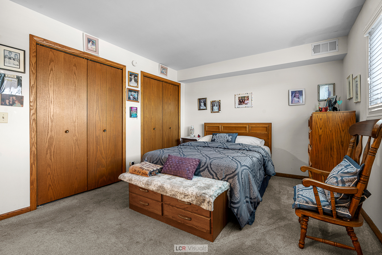 7616 West Lawrence Avenue, Unit 2B Harwood Heights, IL 60706 - Photo 7 of 15 a bedroom with a bed and chair