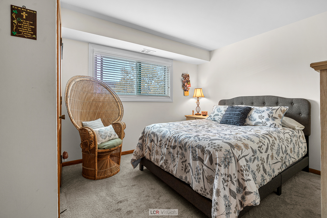 7616 West Lawrence Avenue, Unit 2B Harwood Heights, IL 60706 - Photo 10 of 15 a bedroom with a bed and a window