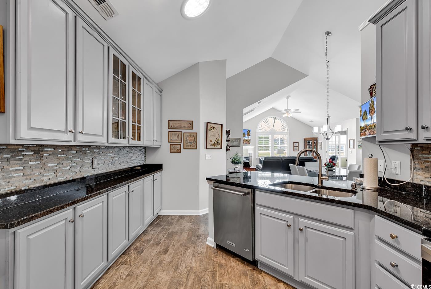 109 Stonegate Boulevard, Unit 109 Murrells Inlet, SC 29576 - Photo 14 of 39 Kitchen featuring gray cabinets, vaulted ceiling,