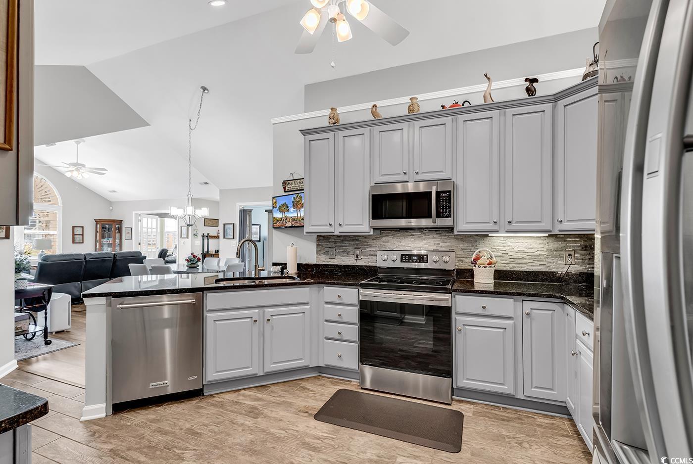 109 Stonegate Boulevard, Unit 109 Murrells Inlet, SC 29576 - Photo 15 of 39 Kitchen featuring a peninsula, a sink, stainless s