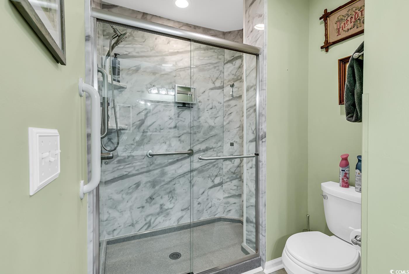109 Stonegate Boulevard, Unit 109 Murrells Inlet, SC 29576 - Photo 21 of 39 Full bath with toilet and a marble finish shower