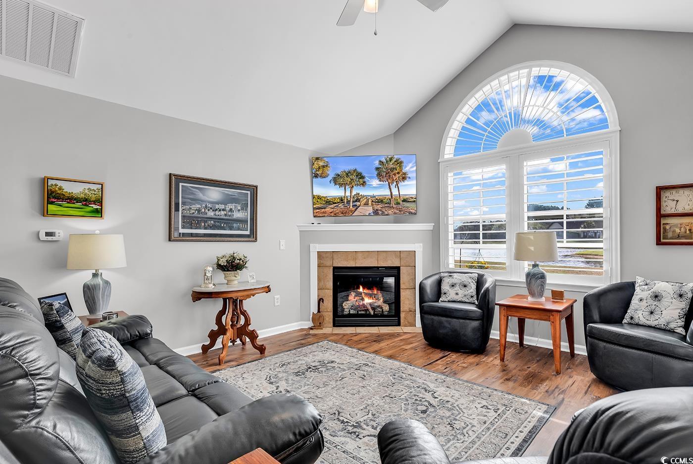 109 Stonegate Boulevard, Unit 109 Murrells Inlet, SC 29576 - Photo 7 of 39 Living room with visible vents, a tile fireplace,