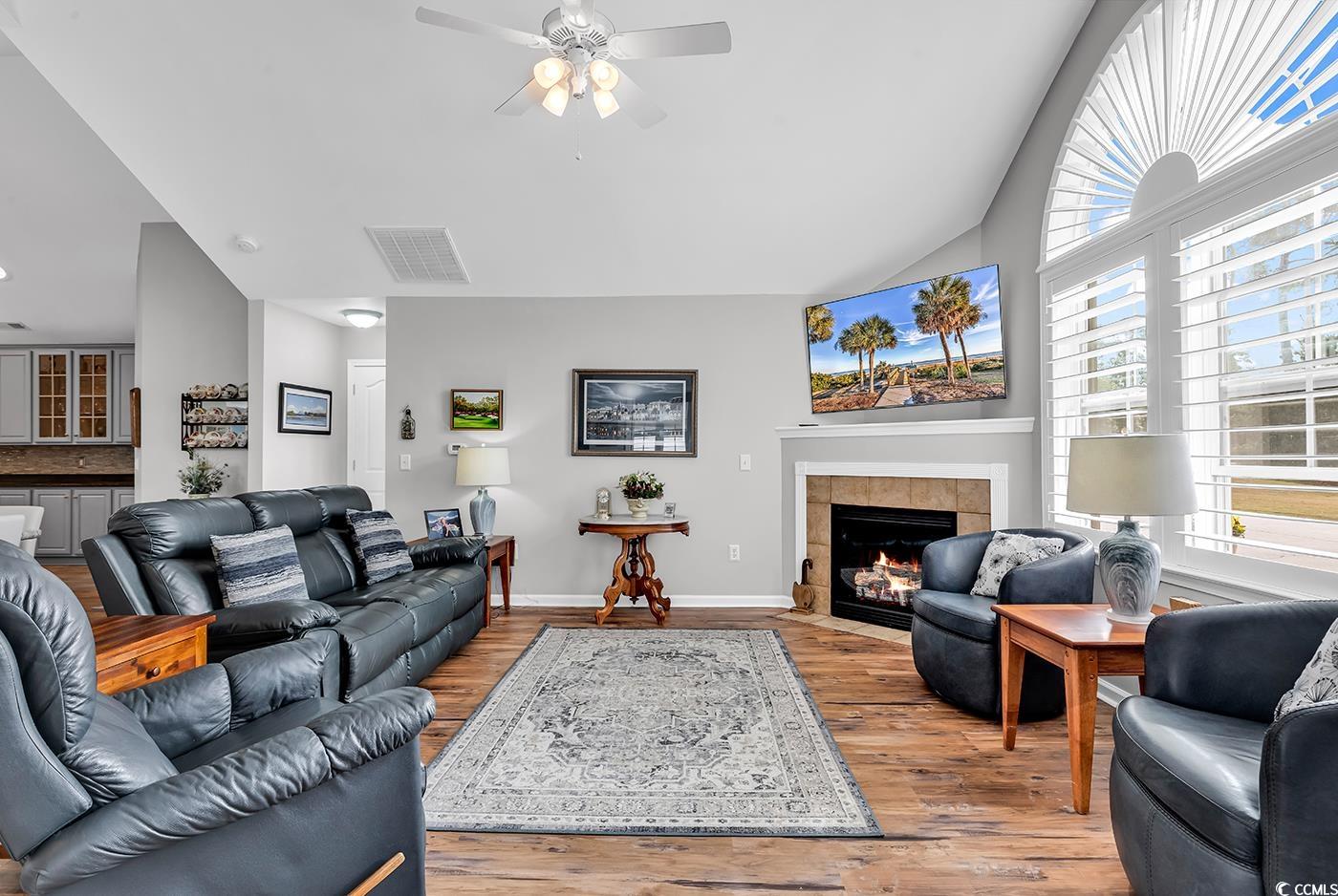 109 Stonegate Boulevard, Unit 109 Murrells Inlet, SC 29576 - Photo 8 of 39 Living area featuring a tiled fireplace, a ceiling