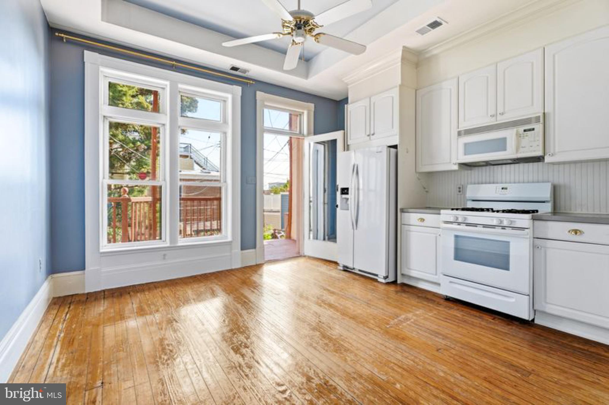2033 East Pratt Street Baltimore, MD 21231 - Photo 19 of 61 a view of a kitchen with wooden floor and a window