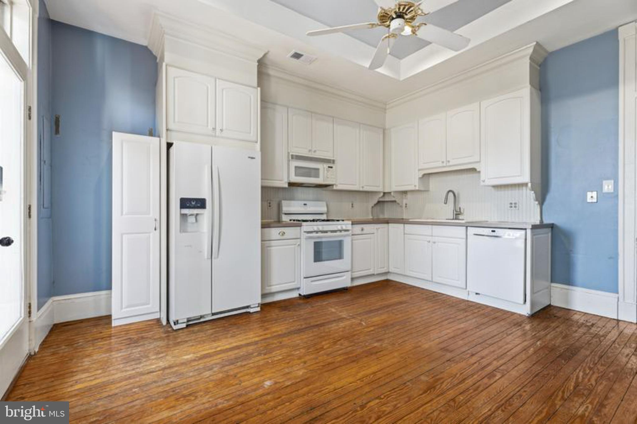 2033 East Pratt Street Baltimore, MD 21231 - Photo 22 of 61 a kitchen with stainless steel appliances a sink cabinets and wooden floor