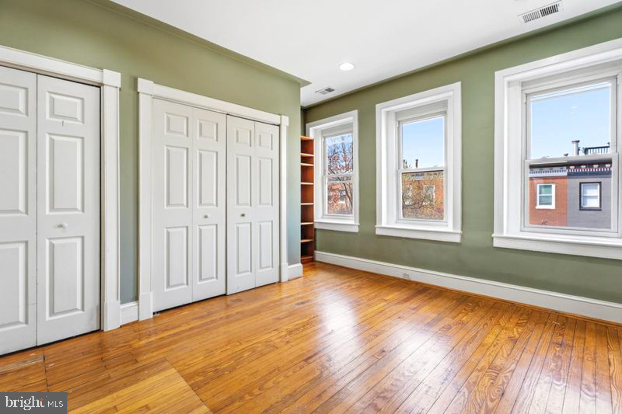 2033 East Pratt Street Baltimore, MD 21231 - Photo 24 of 61 a view of an empty room with window and wooden floor
