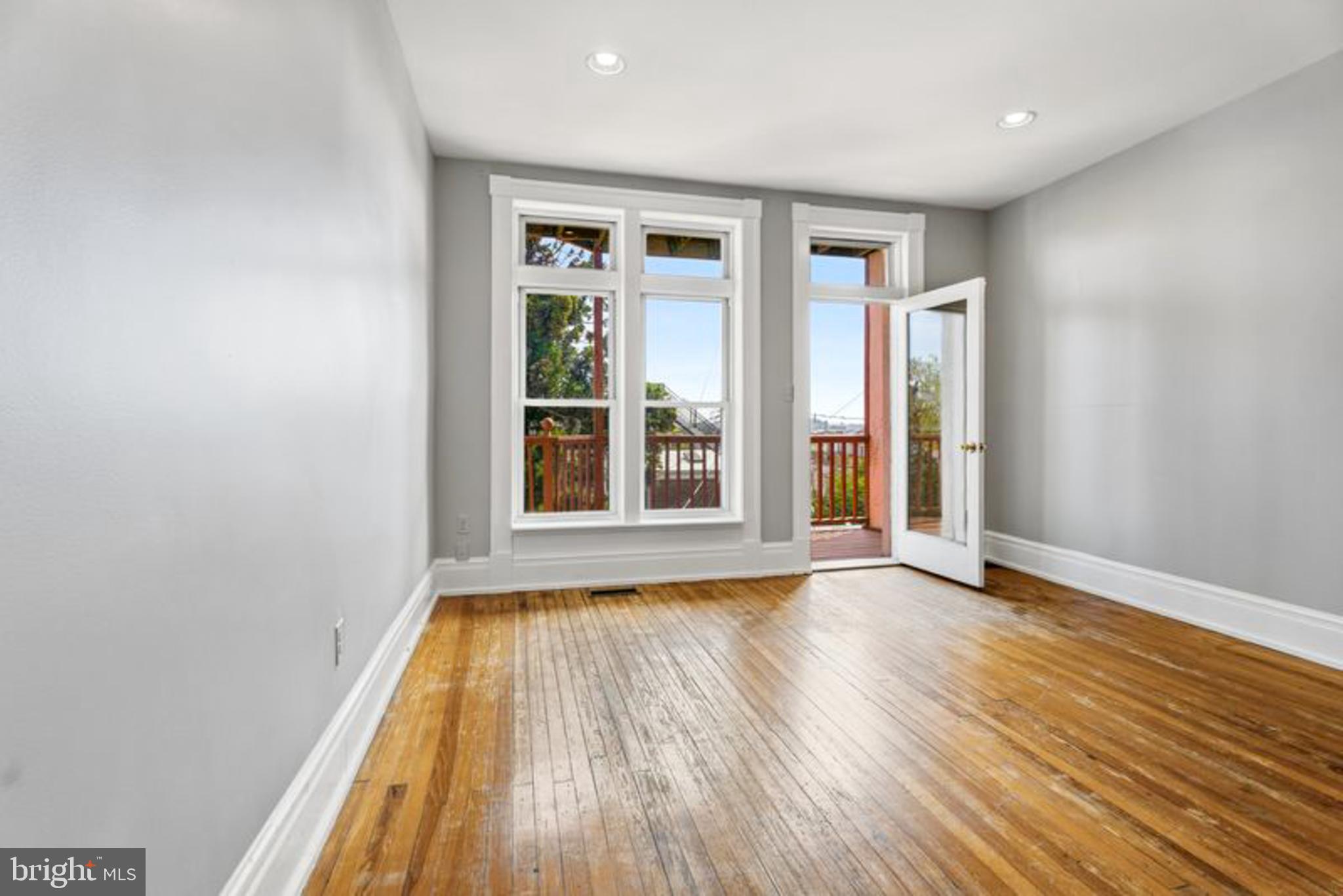 2033 East Pratt Street Baltimore, MD 21231 - Photo 29 of 61 wooden floor in an empty room with a window