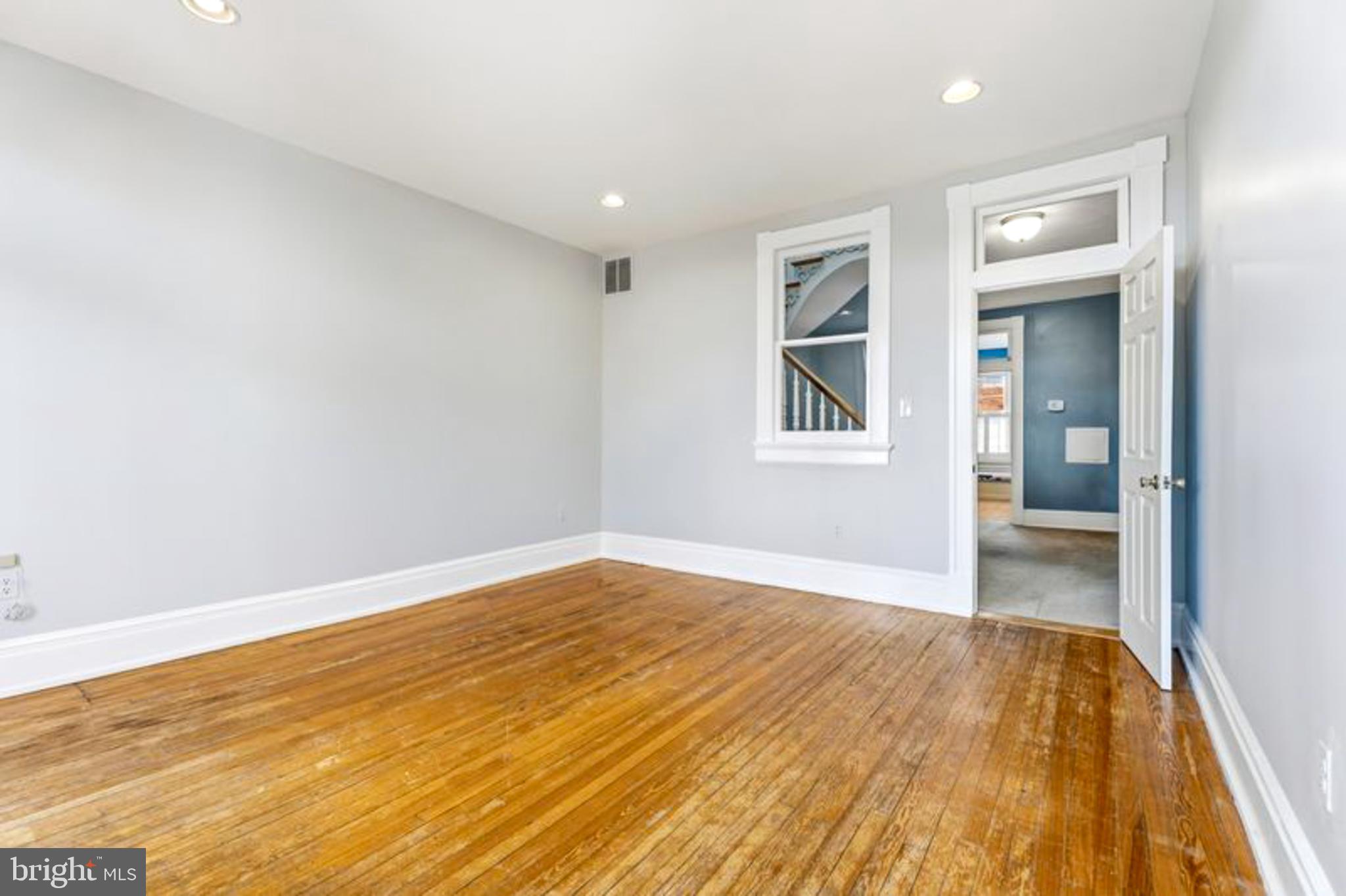 2033 East Pratt Street Baltimore, MD 21231 - Photo 30 of 61 a view of empty room with wooden floor and fan