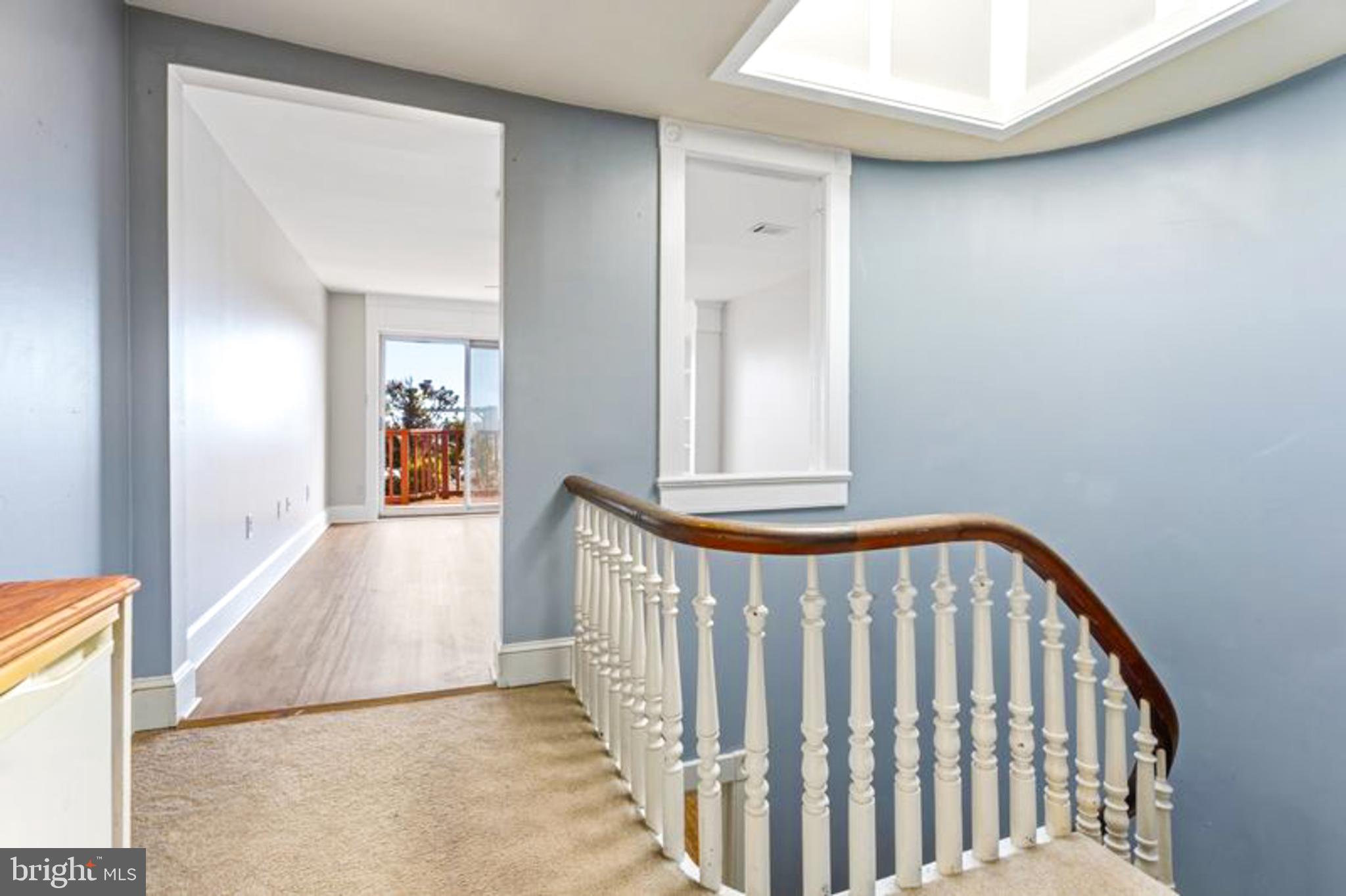 2033 East Pratt Street Baltimore, MD 21231 - Photo 39 of 61 a view of a hallway with wooden floor and a bathroom