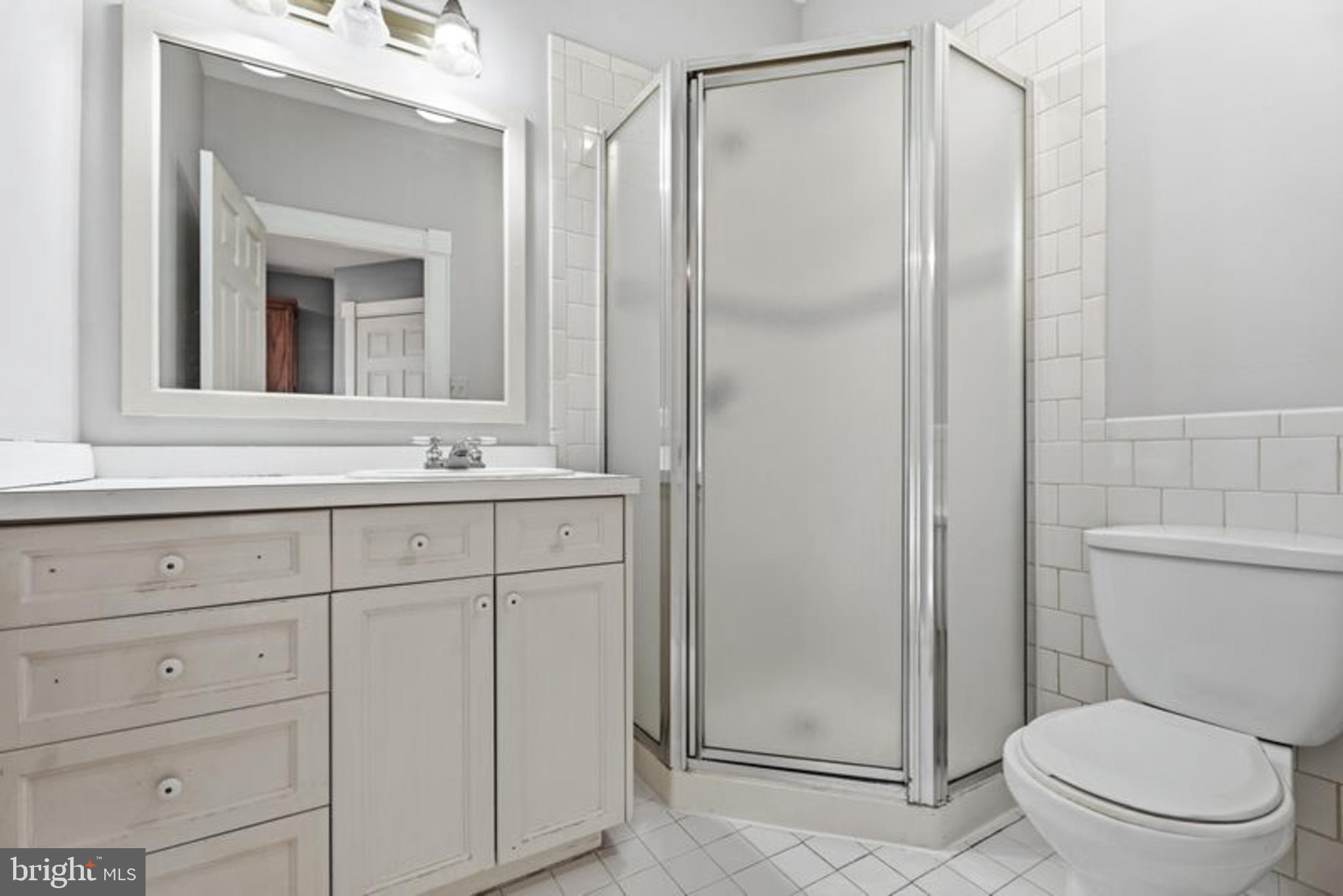 2033 East Pratt Street Baltimore, MD 21231 - Photo 40 of 61 a bathroom with a sink a toilet and shower