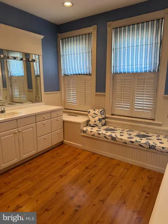 a view of a kitchen with wooden floor and staircase
