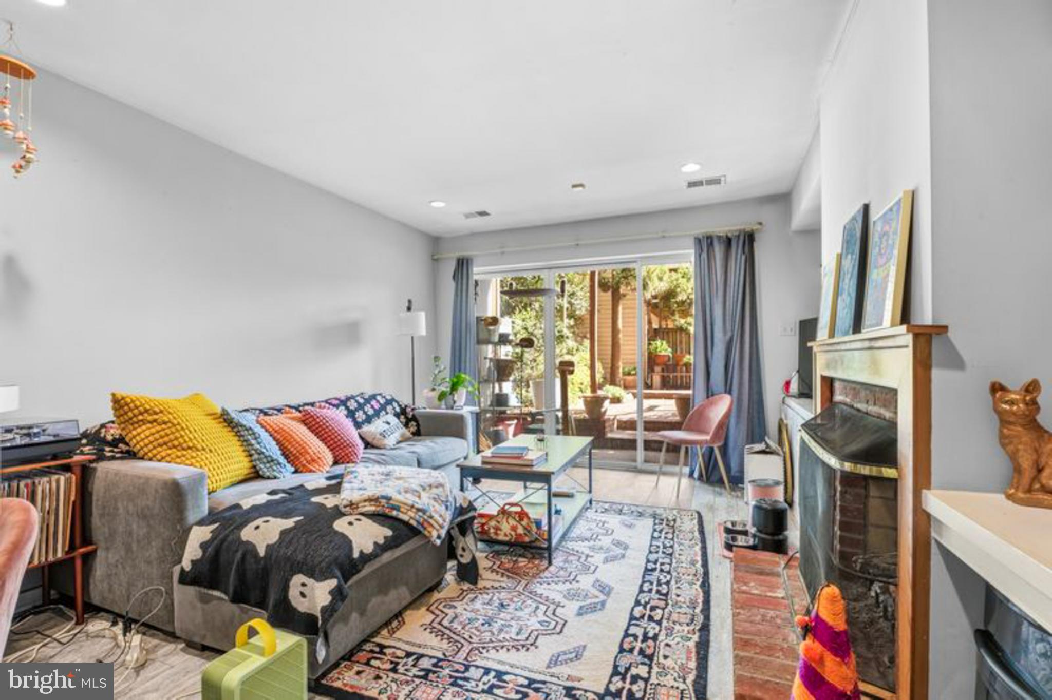 2033 East Pratt Street Baltimore, MD 21231 - Photo 55 of 61 a living room with furniture a flat screen tv and a floor to ceiling window