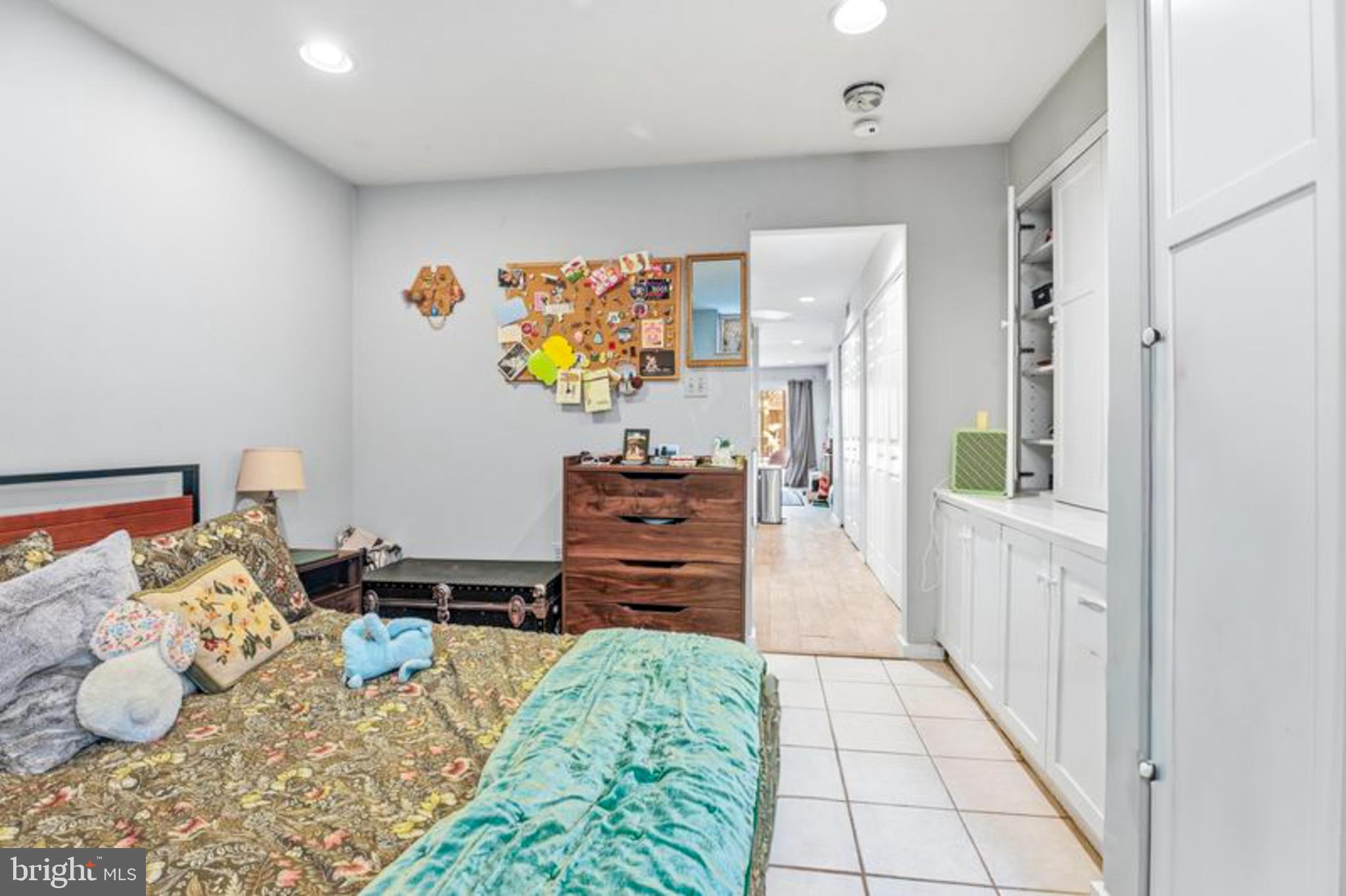 2033 East Pratt Street Baltimore, MD 21231 - Photo 61 of 61 a hallway with a baby crib and dresser