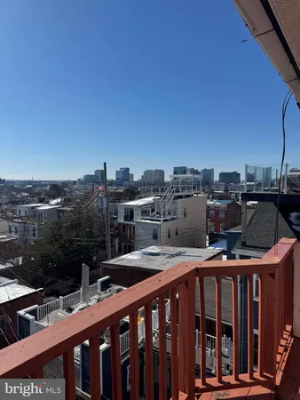 a view of a balcony with two chairs and a outdoor space