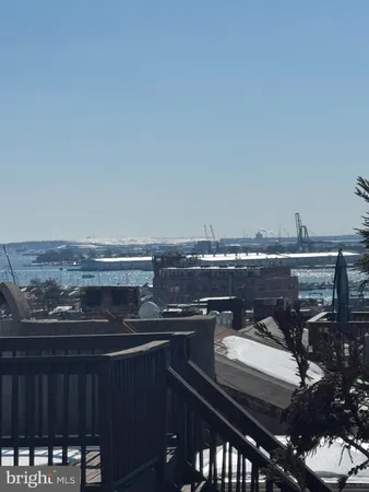 a view of a roof deck with furniture