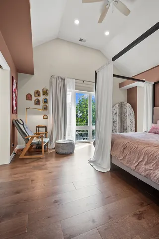 a bedroom with bed and a large window