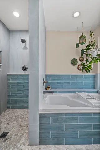 a bathroom with a bathtub and shower