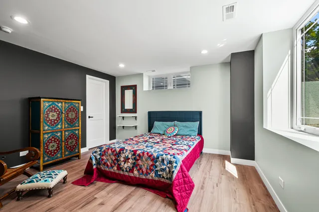 a bedroom with a bed and a large mirror