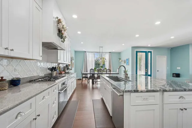 a kitchen with stove a sink and cabinets
