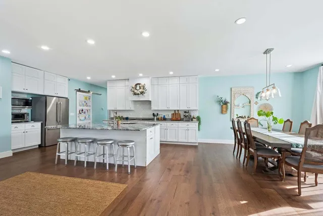 a large kitchen with a table and chairs