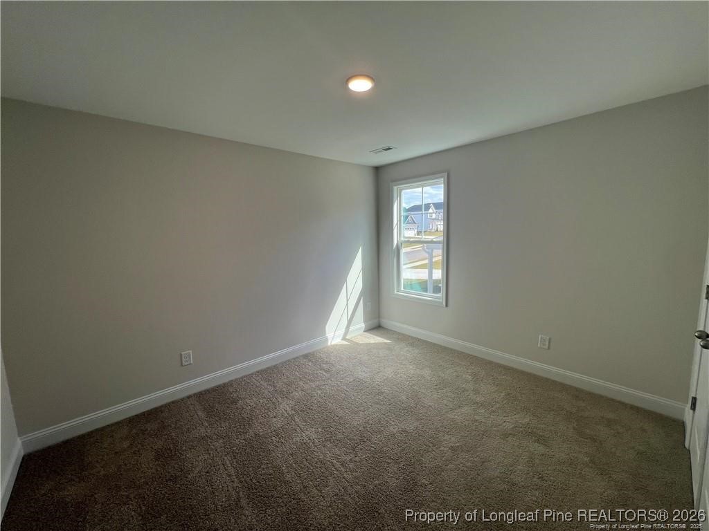 3870 Blackhills Road Fayetteville, NC 28311 - Photo 16 of 22 an empty room with windows and closet