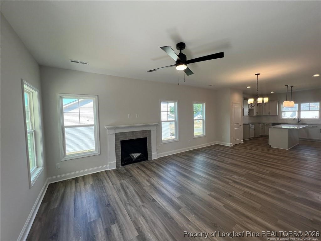 3870 Blackhills Road Fayetteville, NC 28311 - Photo 6 of 22 a view of empty room with wooden floor and fireplace