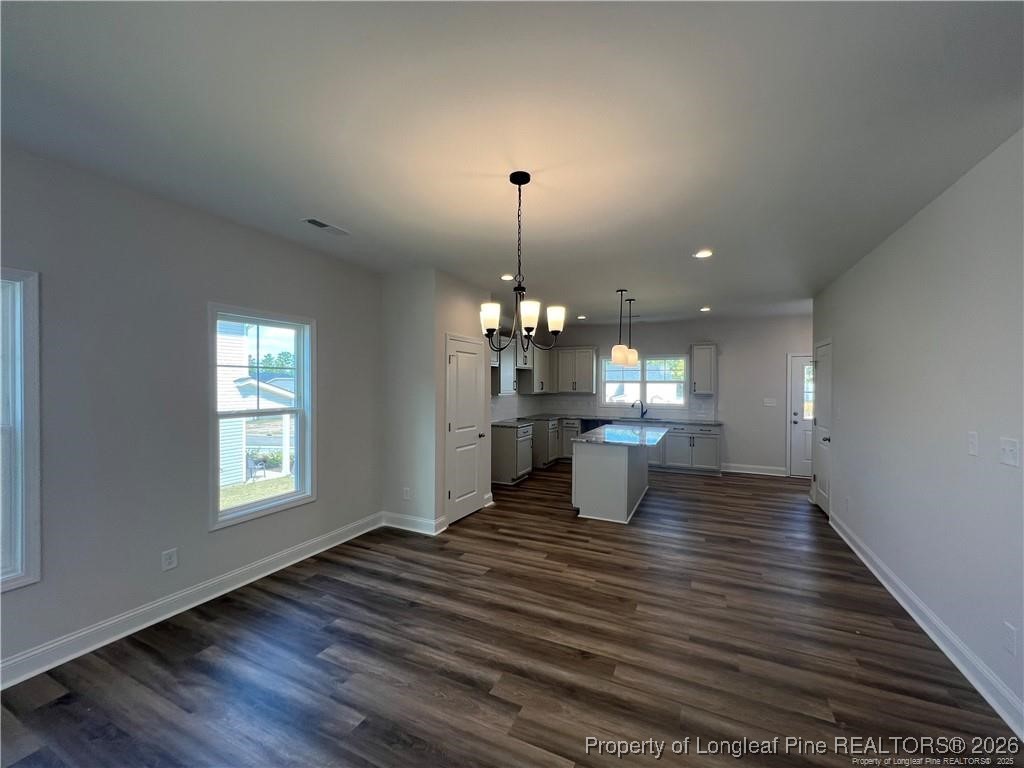 3870 Blackhills Road Fayetteville, NC 28311 - Photo 7 of 22 a view of a room with wooden floor kitchen view and a window