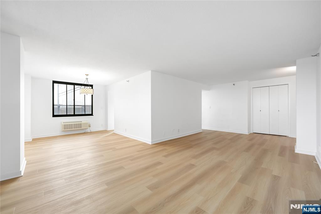 316 Prospect Avenue, Unit 4E Hackensack, NJ 07601 - Photo 14 of 19 a view of an empty room with window and wooden floor