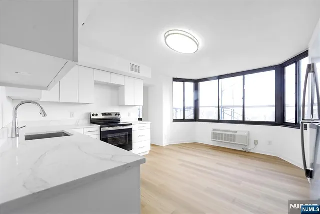 a large kitchen with a stove a sink and a refrigerator
