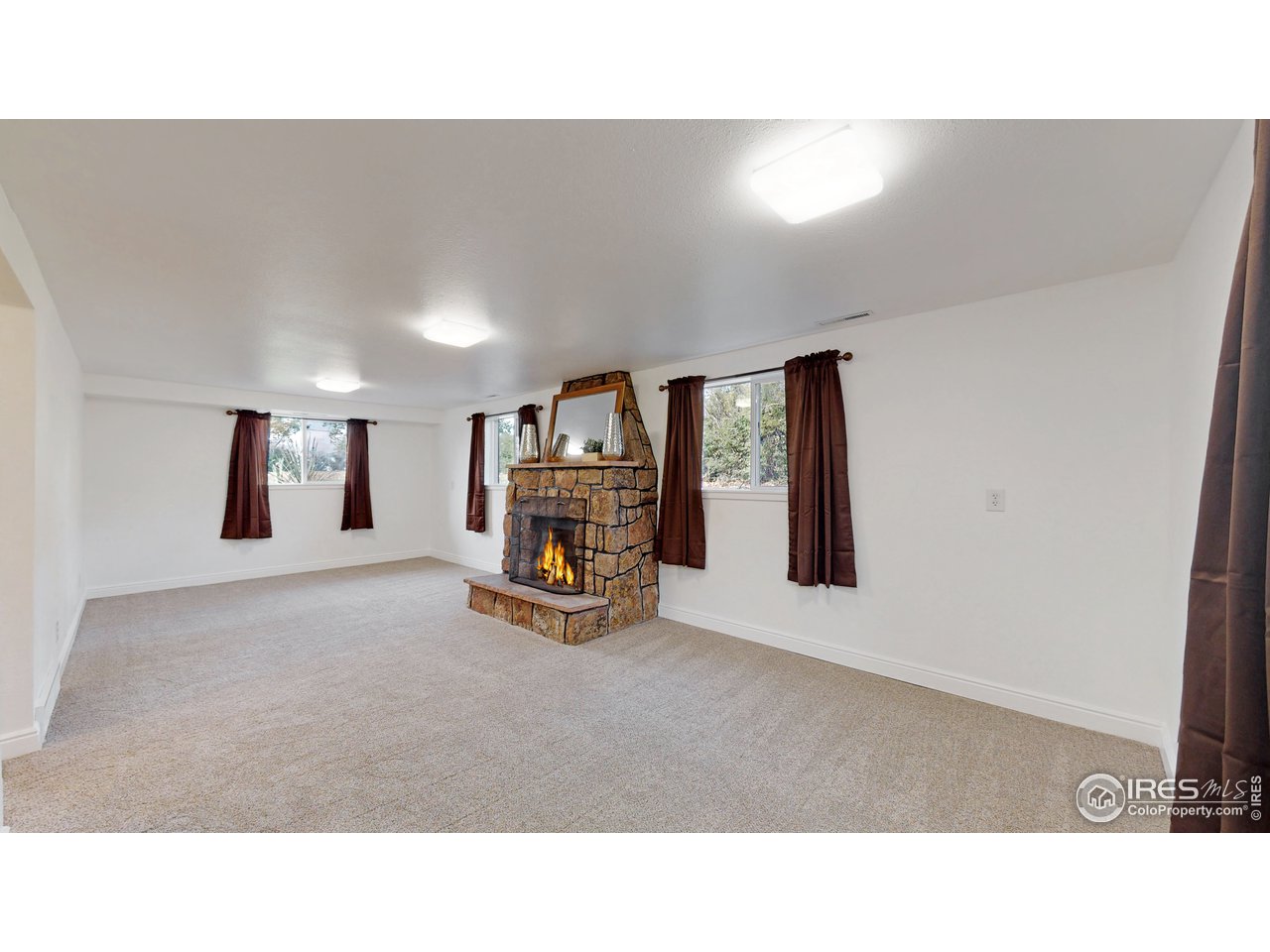 3324 Terry Lake Road Fort Collins, CO 80524 - Photo 22 of 40 Family Room w/ Fireplace (Lower Level)